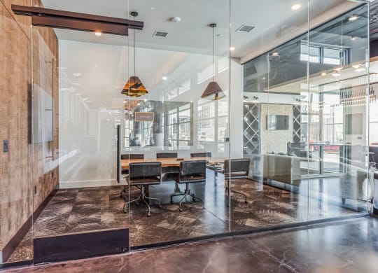a conference room with glass walls and a table and chairs  at South and Hollis, Charlotte, NC, 28209