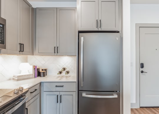a kitchen with white cabinets and a stainless steel refrigerator at South and Hollis, Charlotte, NC, 28209