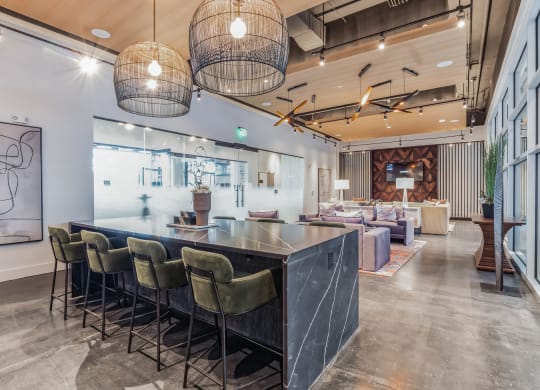 the lobby of a restaurant with a long bar and chairs at South and Hollis, Charlotte, 28209