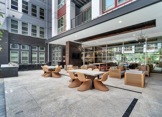 a patio with tables and chairs outside of a building at South and Hollis, Charlotte