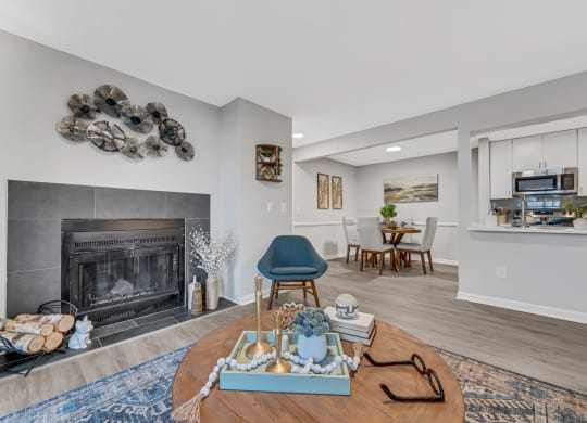 a living room with a fireplace and a dining room in the background at Brampton Moors, Cary