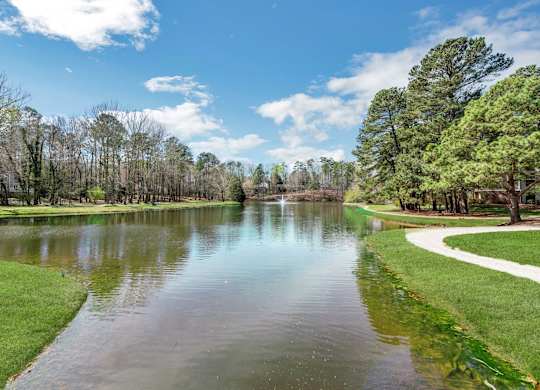 A serene lake surrounded by trees and a clear sky at Brampton Moors, Cary, NC, 27513