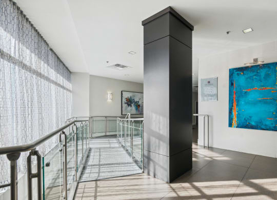the lobby of a building with stairs and a blue painting at The Gramax, Silver Spring, Maryland