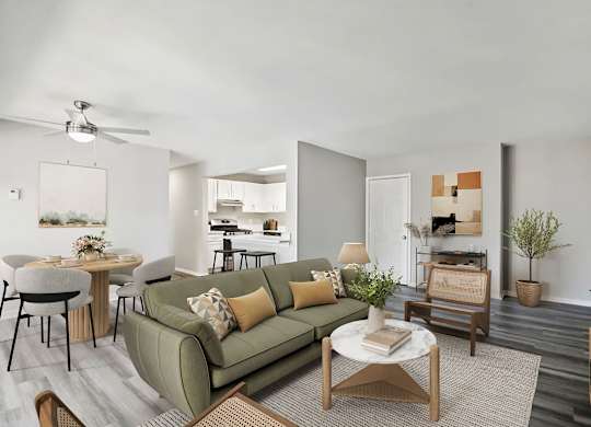 A living room with a green couch and a coffee table at The Overlook at Quantico Apartments, Triangle, VA, 22172