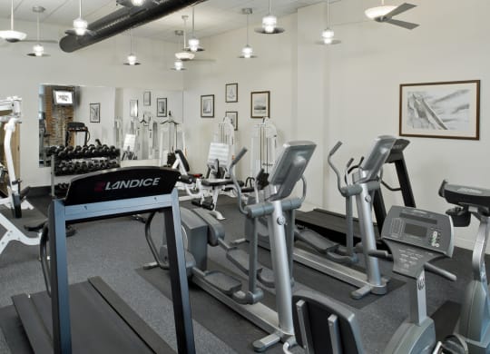 a gym with treadmills and other exercise equipment at Tindeco Wharf, Baltimore, MD 21224