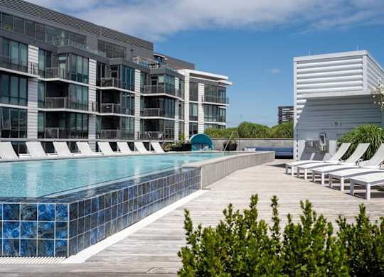 A modern building with a pool in front. at Dock 79, Washington, DC