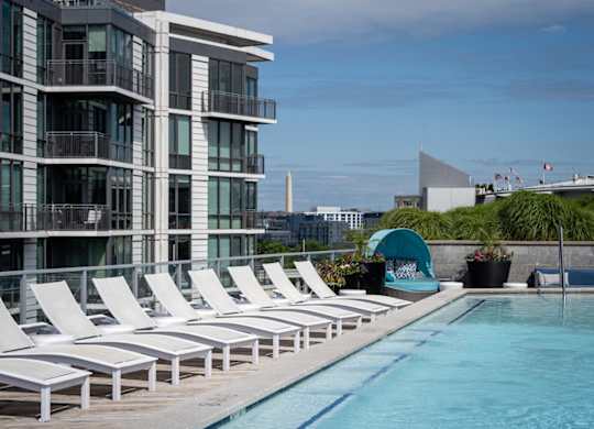 Beautiful pool with sun loungers in front of a building. at Dock 79, Washington, 20003