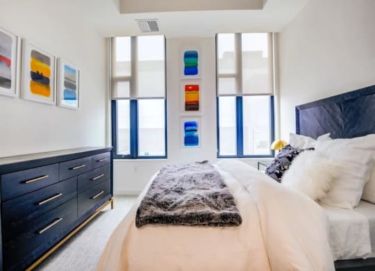 a bedroom with a bed and a dresser at The Boro, Virginia, 22102