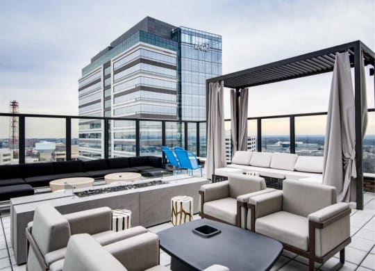 a living room filled with furniture and a fire pit at The Boro, Tysons, VA 22102