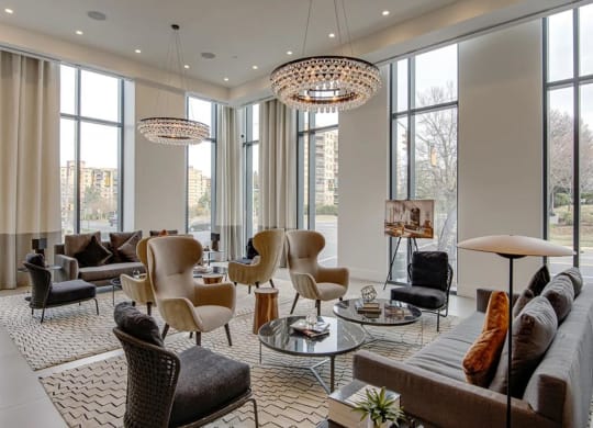 a living room filled with furniture and large windows at The Boro, Tysons, 22102