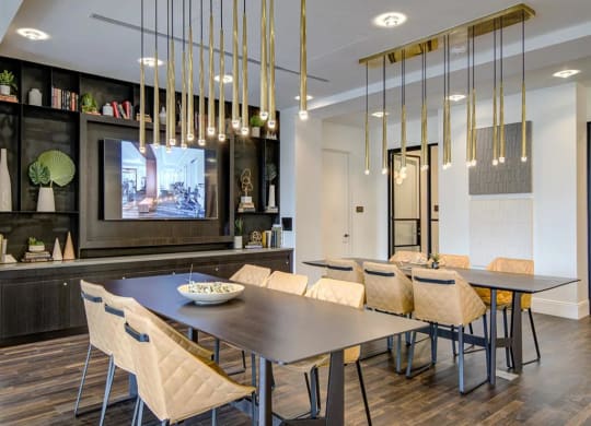 a dining room with a table and chairs and a tv in the background at The Boro, Tysons Virginia