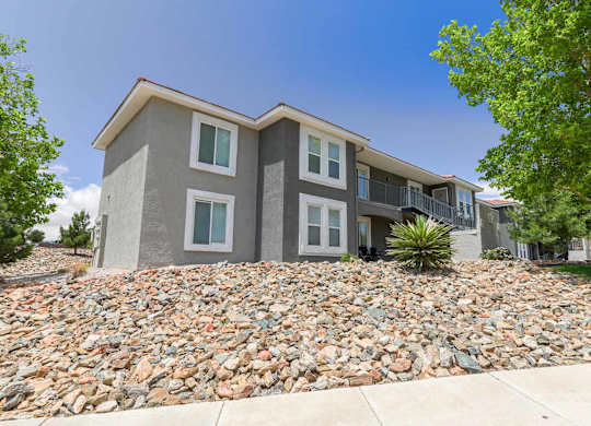 A modern two-story house with a stone foundation at West Park Apartments, Albuquerque