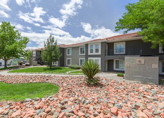 A residential area with houses and a green tree at West Park Apartments, Albuquerque
