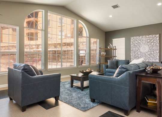 A living room with two grey couches and a coffee table at West Park Apartments, Albuquerque