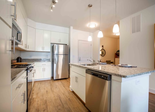 a kitchen with stainless steel appliances and granite counter tops at Woodmore Grand, Bowie, 20721