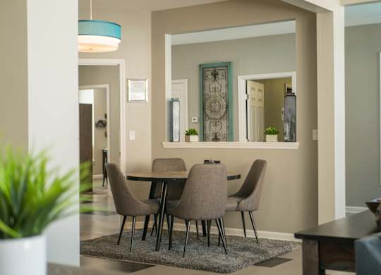 A dining room with a table and chairs at West Park Apartments, Albuquerque