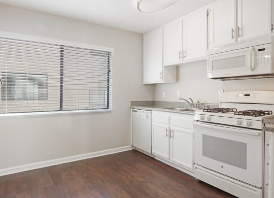 Kitchen With White Cabinetry And Appliances at Superior Place, Northridge, CA