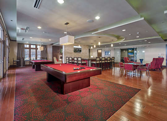 A room with a pool table and a red carpet at Vermella Lyndhurst apartments, Lyndhurst