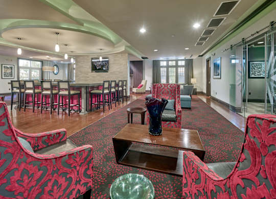 A room with red patterned chairs and a wooden table at Vermella Lyndhurst apartments, New Jersey
