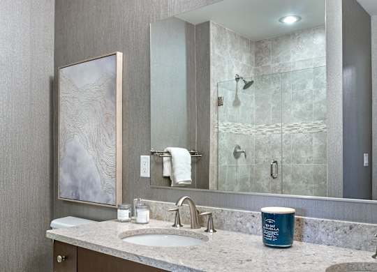 Double sink bathroom with vanity mirror at Vermella Lyndhurst apartments, New Jersey