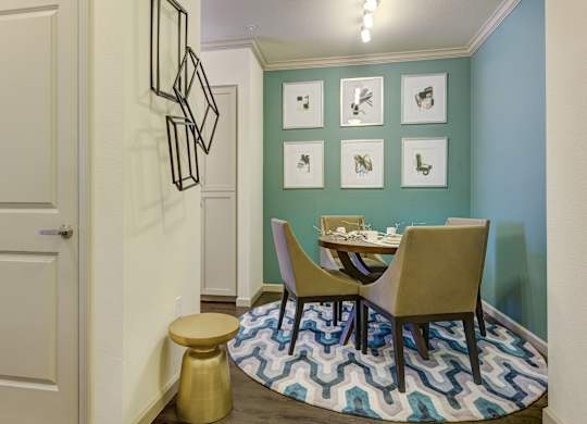 A dining area with a table and chairs.