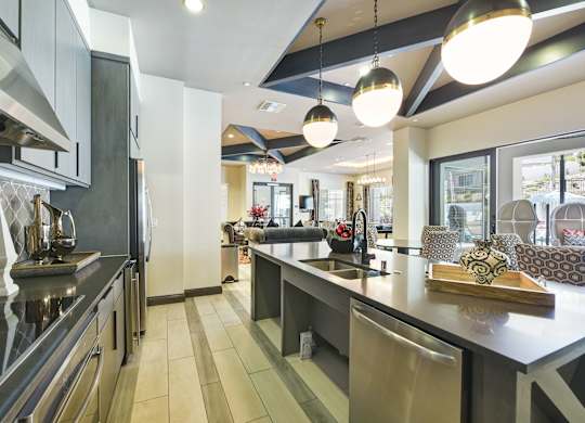 A modern kitchen with stainless steel appliances and a central island.