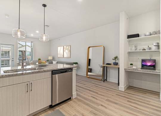 A modern kitchen with wooden floors and stainless steel appliances.