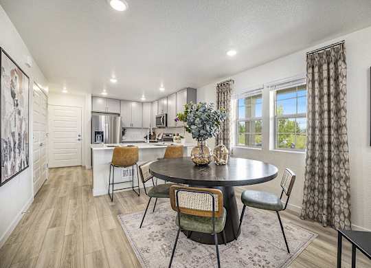 a kitchen and dining room with a table and chairs