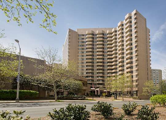 an apartment building with a street in front of it