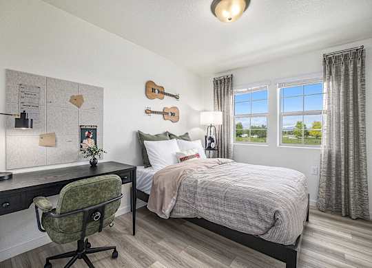 a bedroom with a bed and a desk