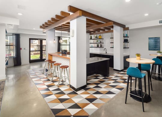 the lobby of a restaurant with a bar and stools