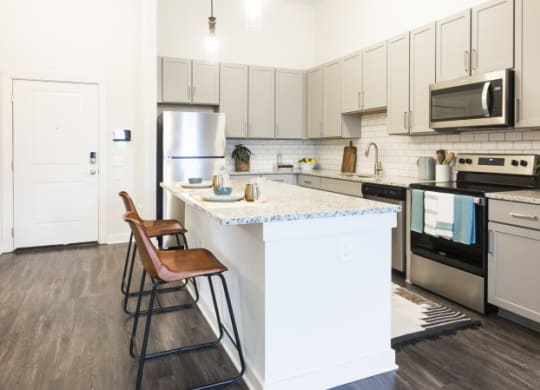 a kitchen with an island with two stools
