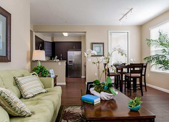 A living room with a green couch and a wooden coffee table.