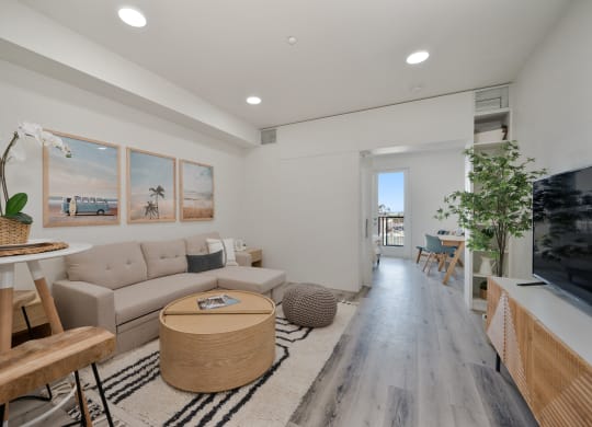 a living room and dining room with a couch and a table