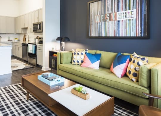 a living room and kitchen with a couch and a coffee table