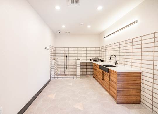 A kitchen with a wooden counter and a tile backsplash.