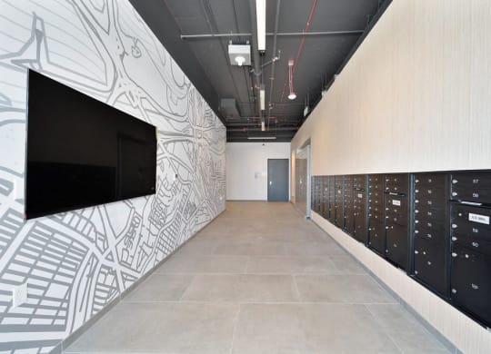 a hallway with lockers and a television on the wall