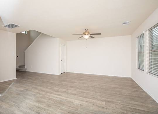 A room with a ceiling fan and light fixture.