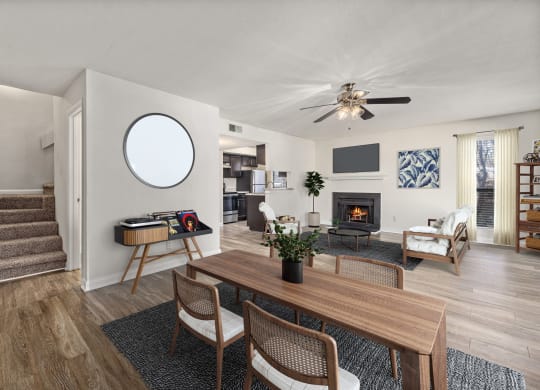 a living room with a dining room table and a fireplace