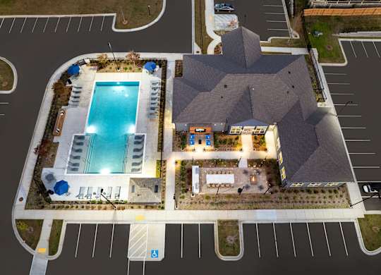 A large building with a pool in front.