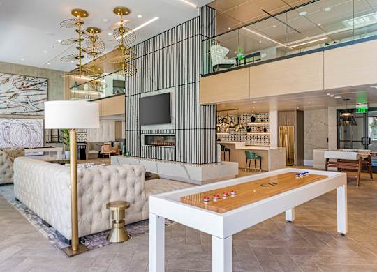 a living room filled with furniture and a table with a board game at Sola at Pacific Highlands Ranch Apartments, San Diego, CA
