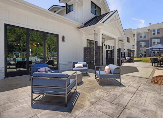 A patio with two lounge chairs and a table.