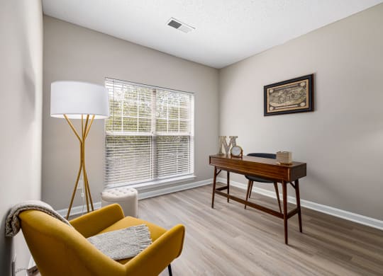 a living room with a couch and a desk and a window at Mariners Crossing, Raleigh