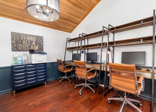 a study room with desks and chairs and a bunk bed