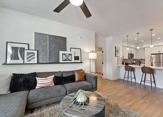 A living room with a grey couch and a coffee table in front of it.