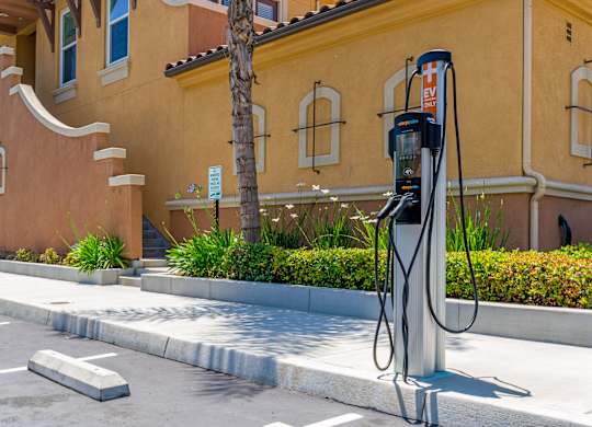 A charging station for electric vehicles is located in front of a building.
