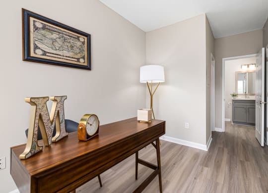a bedroom with a desk and a hallway with a door to a bathroom  at Mariners Crossing, Raleigh, NC 27612