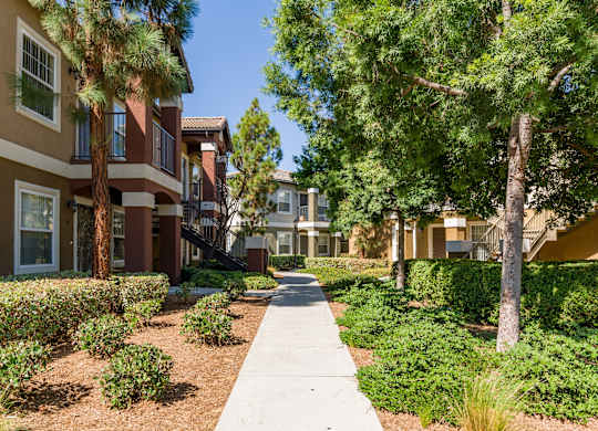 A row of houses with a sidewalk in between at The Landing at Ocean View Hills Apartments