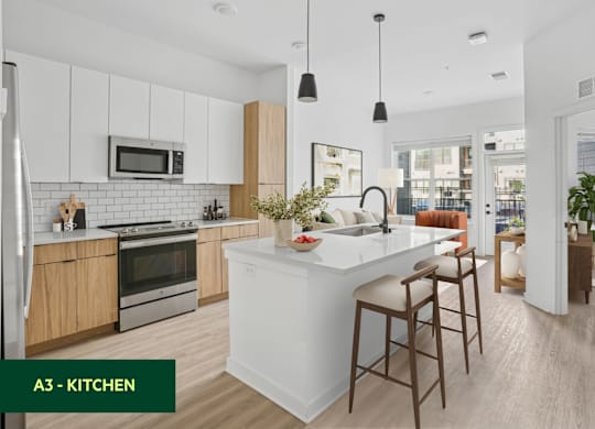 A modern kitchen with a white island and wooden bar stools.