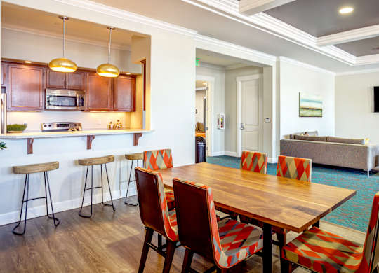 A dining room with a wooden table and chairs.